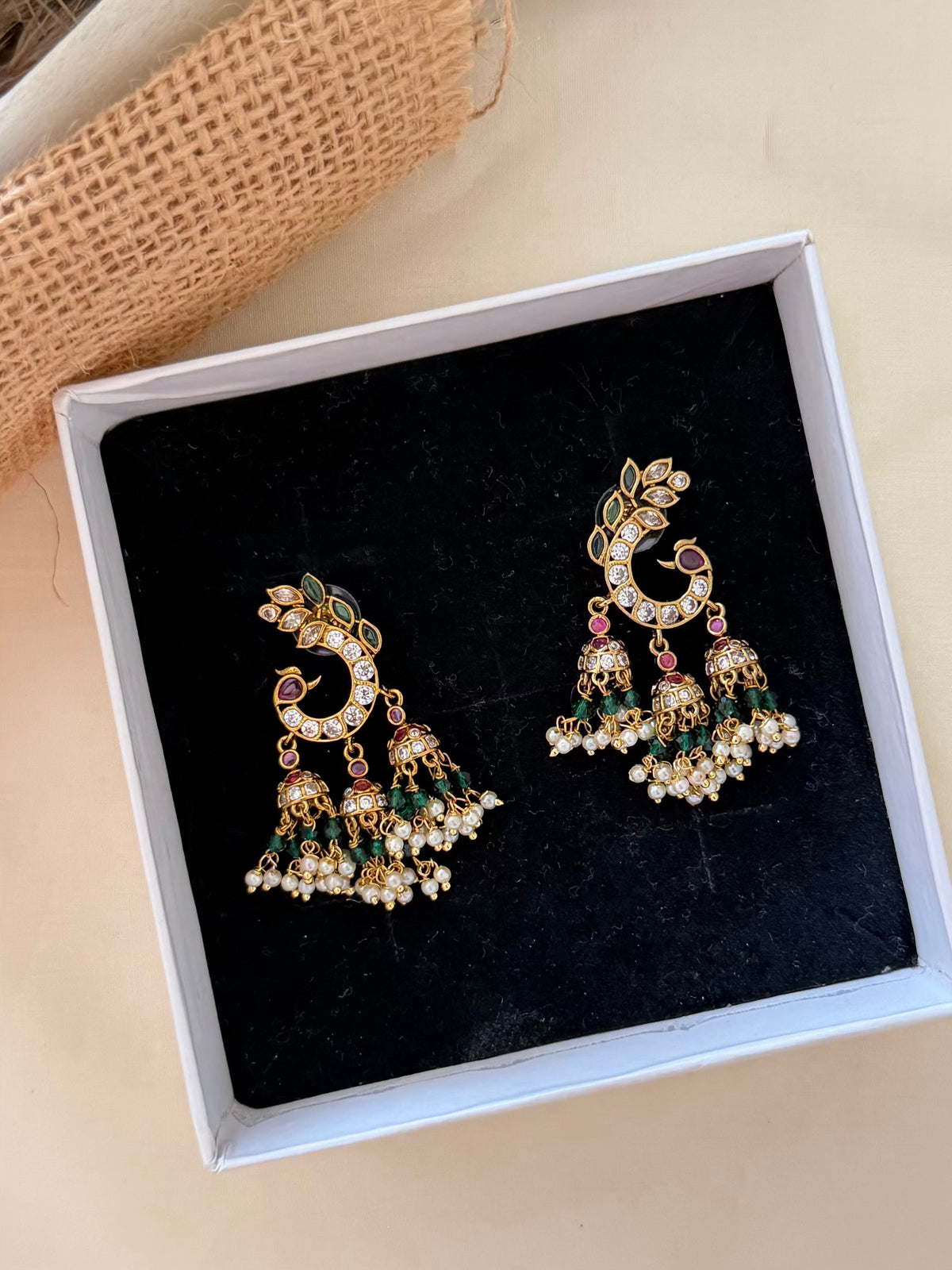 Peacock Crescent Stud Earrings with Triple Mini Jhumka Drops and Green Bead Detail