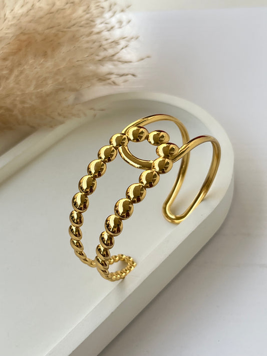 Elegant gold cuff bracelet featuring two rows of shiny gold beads – anti-tarnish and perfect for modern women to add luxe to daily outfits or as a chic gift.