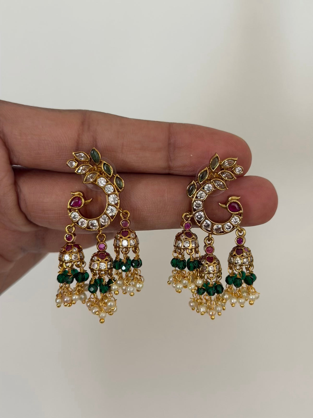 Peacock Crescent Stud Earrings with Triple Mini Jhumka Drops and Green Bead Detail