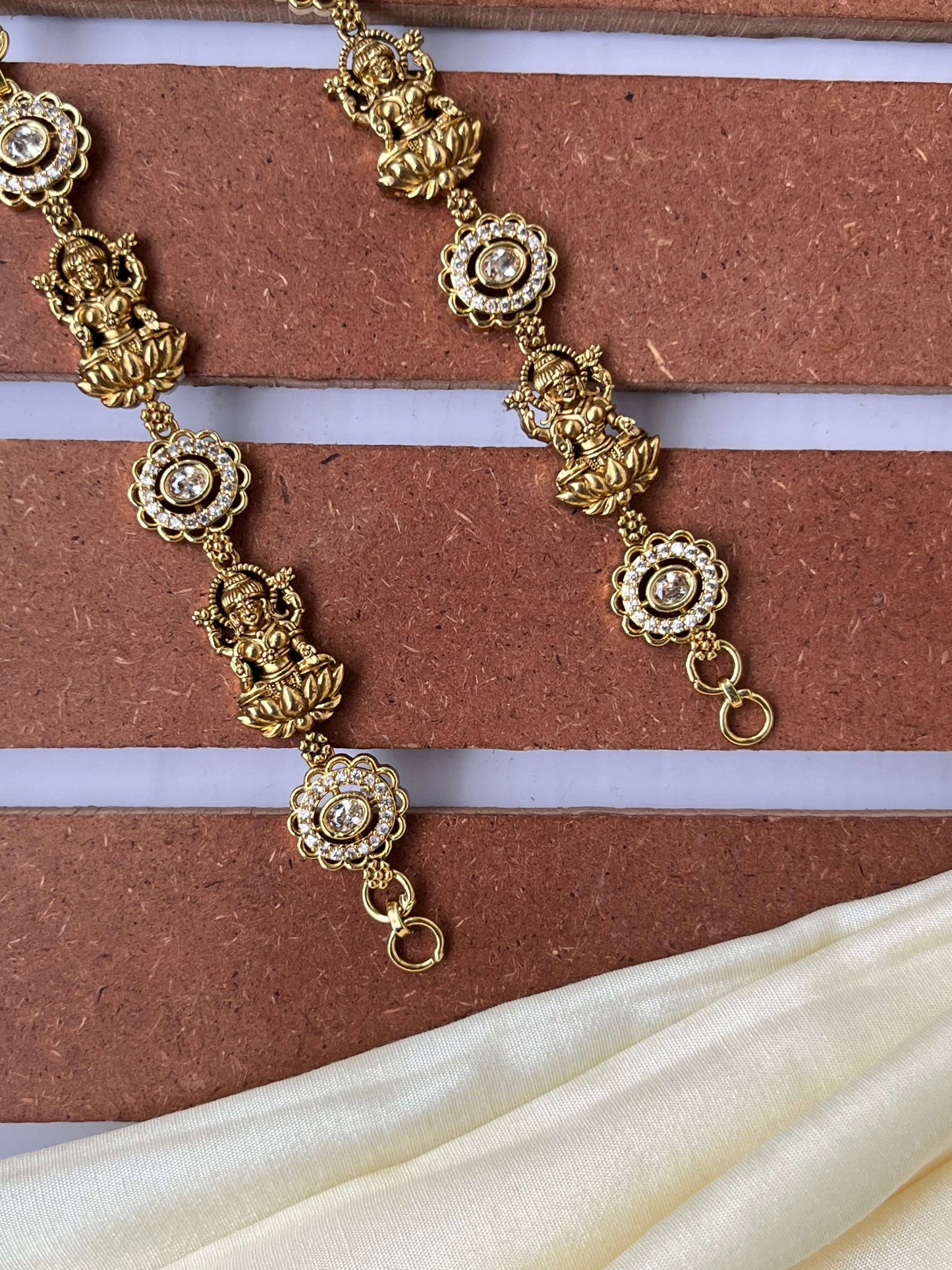 Lakshmi Devi Studded Mattal with Emerald Green Stones – Unique Design