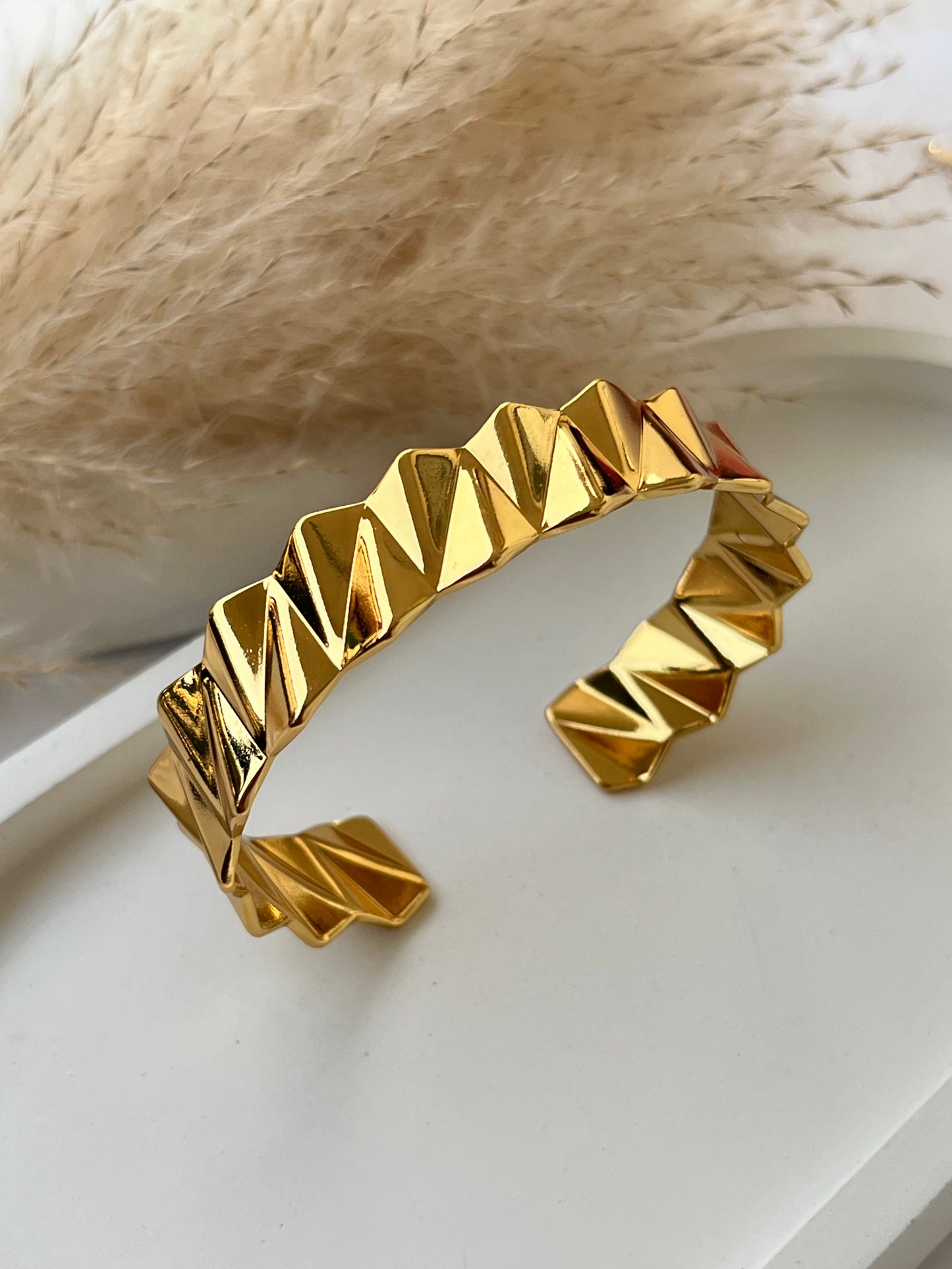 Edgy gold cuff bracelet with a faceted zigzag design and high-shine finish – anti-tarnish and perfect for modern girls who love standout accessories or unique gift pieces.
