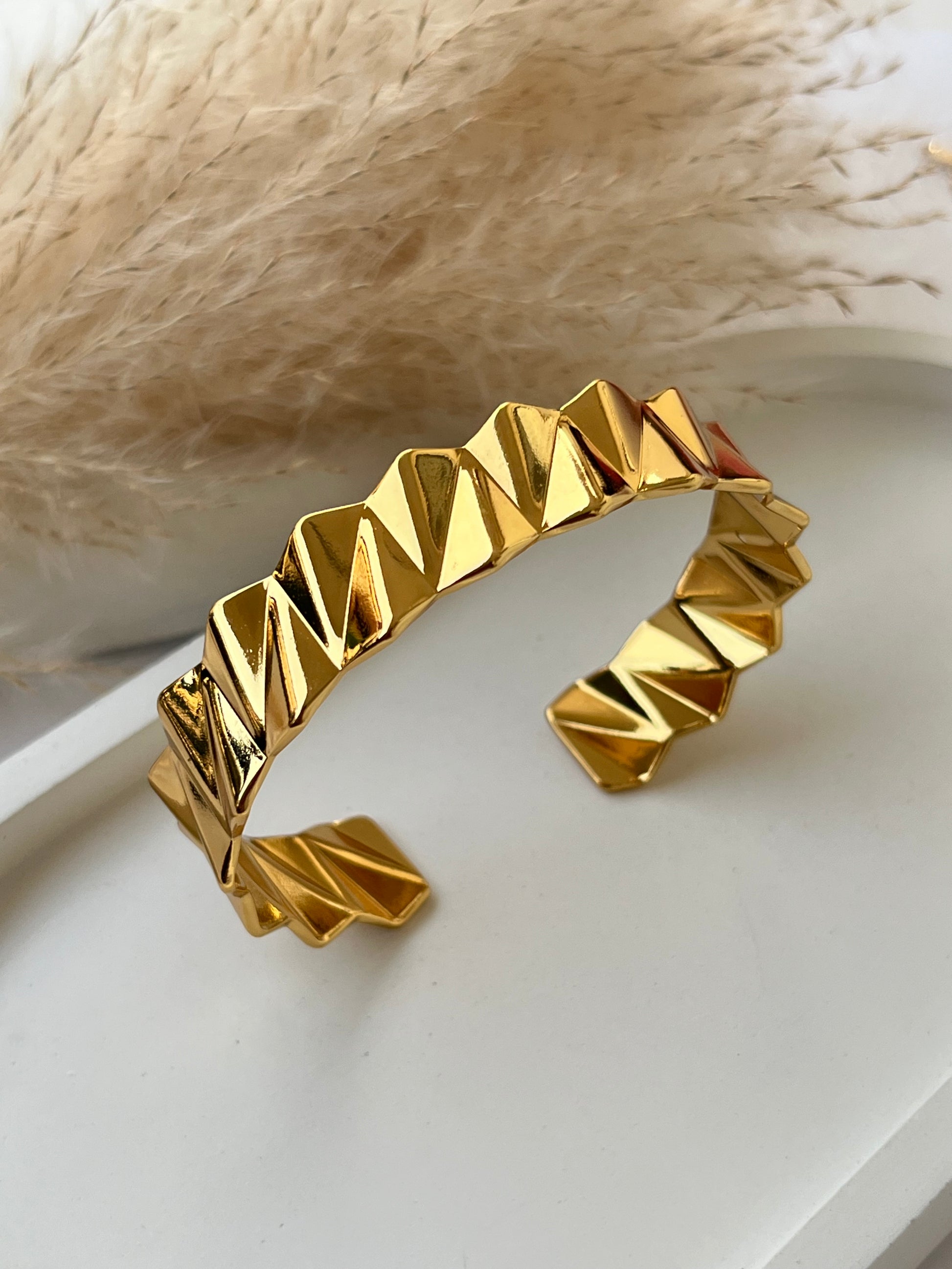 Edgy gold cuff bracelet with a faceted zigzag design and high-shine finish – anti-tarnish and perfect for modern girls who love standout accessories or unique gift pieces.