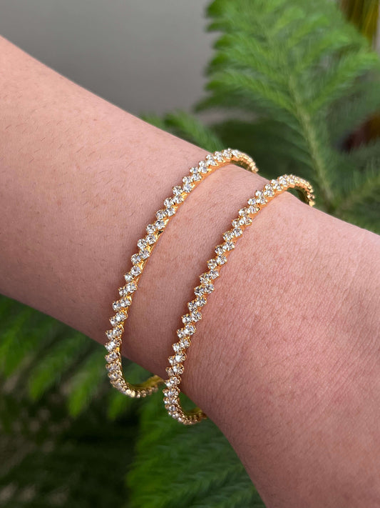 Set of 4 sleek American diamond bangles with gold-like finish – worn on wrist – minimalist everyday jewellery