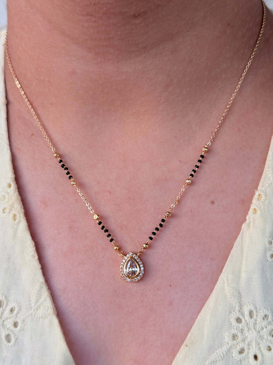 Necklace with a pendant worn by a person, close-up view.
