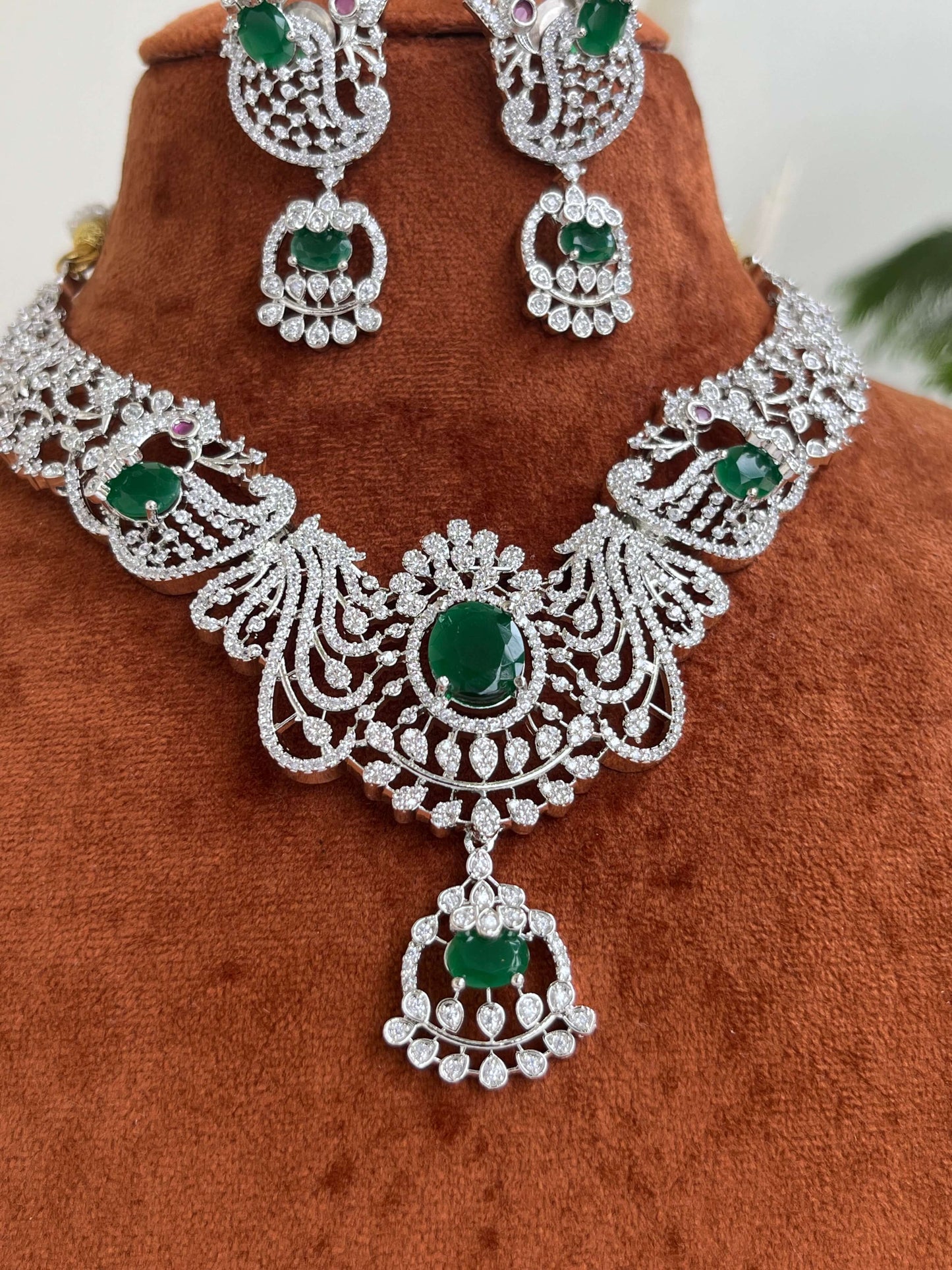 Silver Finish Peacock Design Necklace Set with Emerald Green Stones