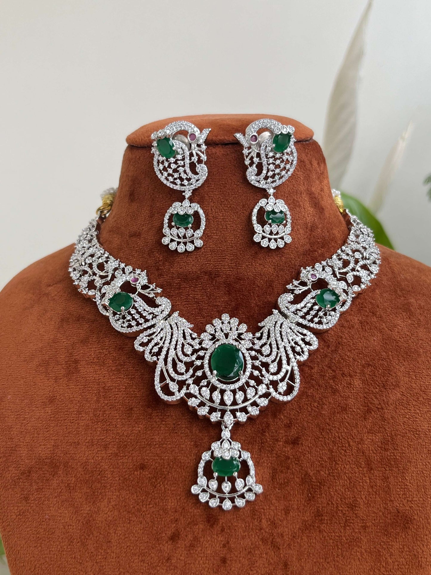 Silver Finish Peacock Design Necklace Set with Emerald Green Stones