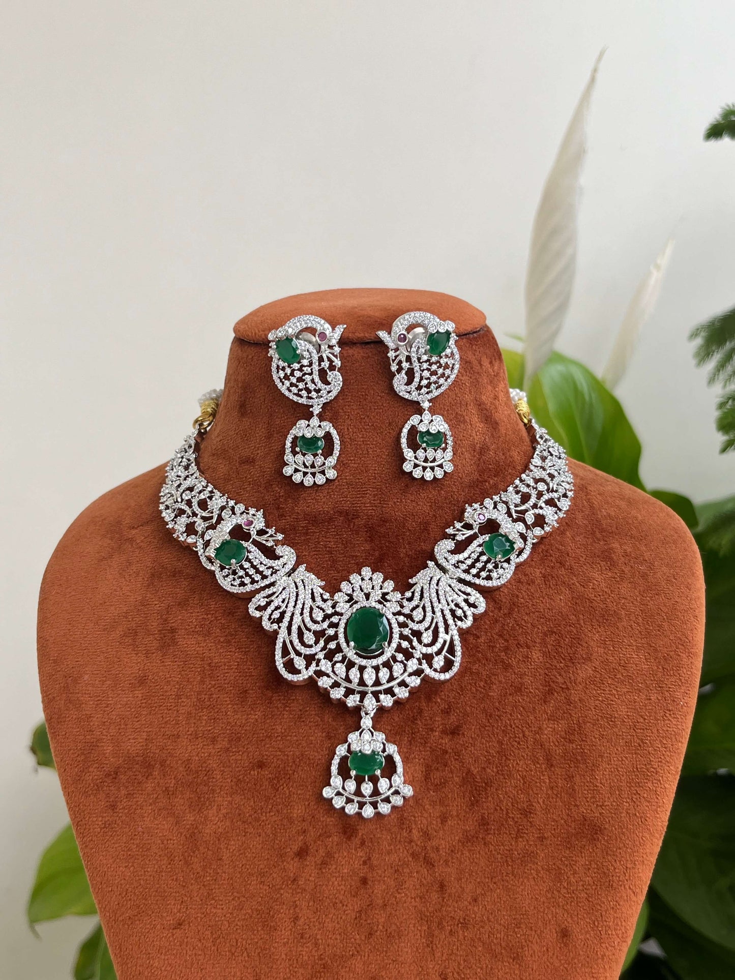 Silver Finish Peacock Design Necklace Set with Emerald Green Stones