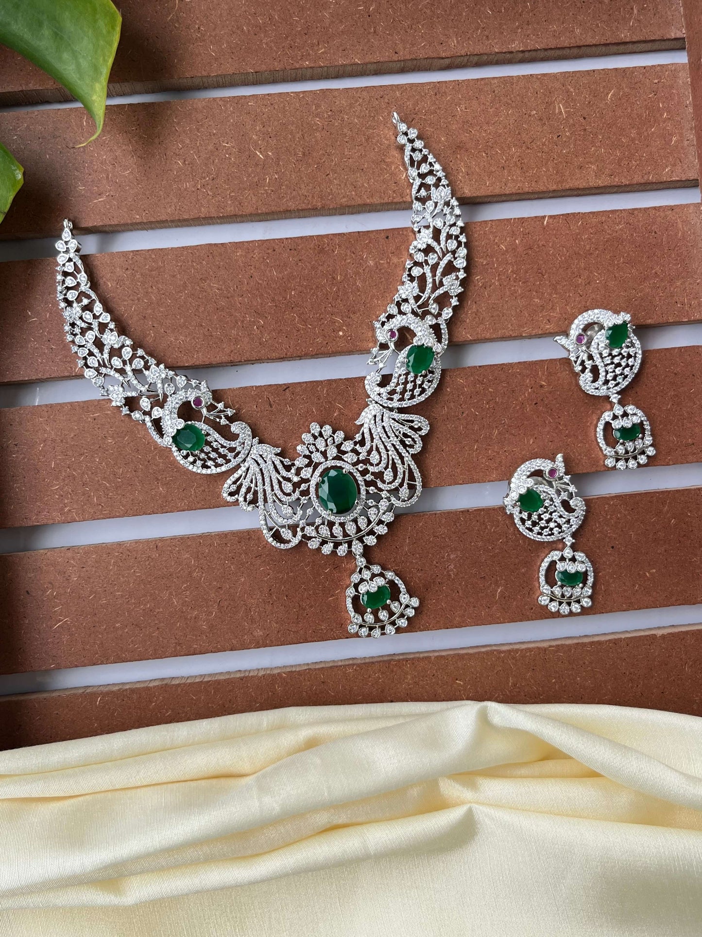 Silver Finish Peacock Design Necklace Set with Emerald Green Stones
