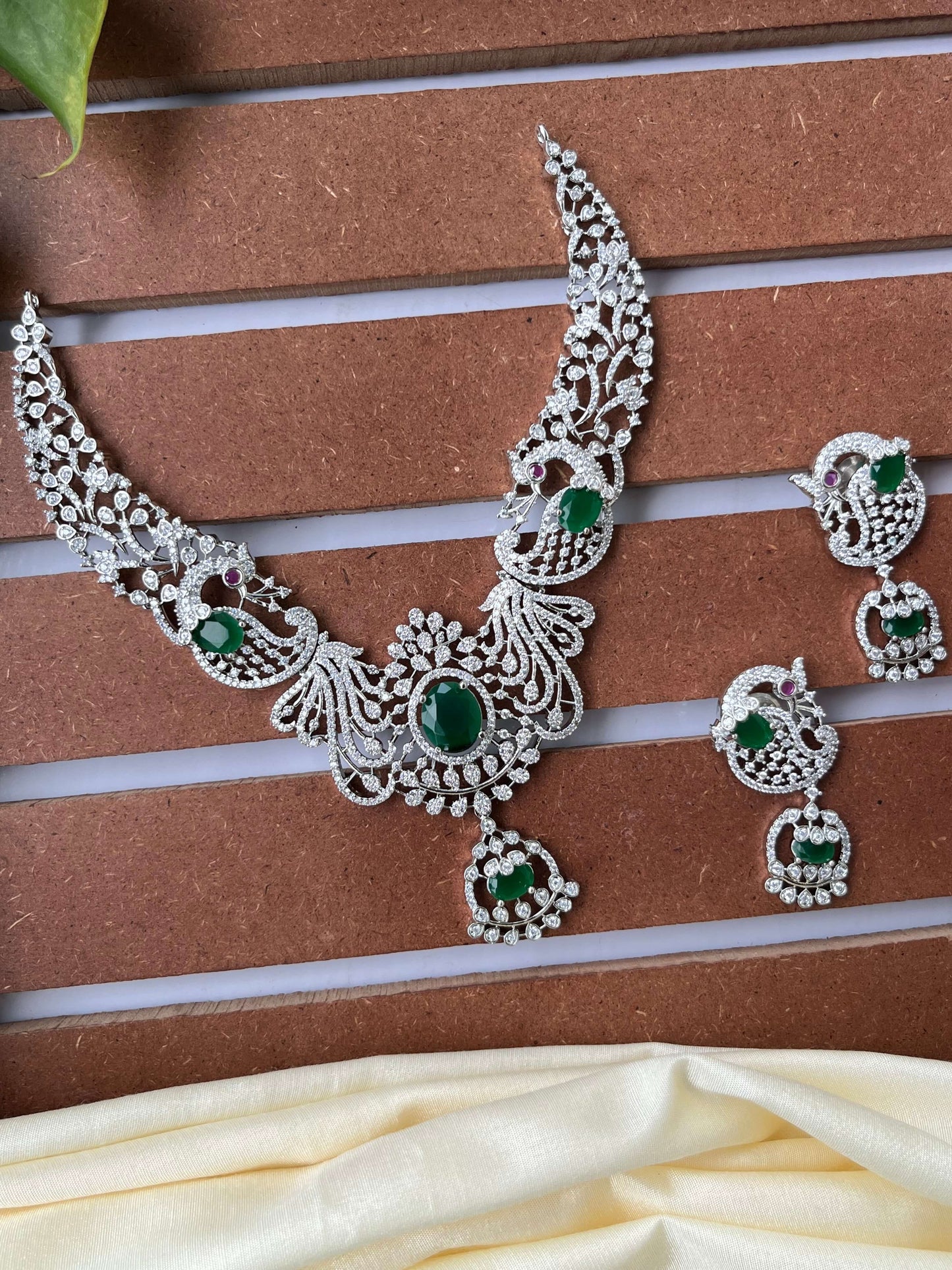 Silver Finish Peacock Design Necklace Set with Emerald Green Stones