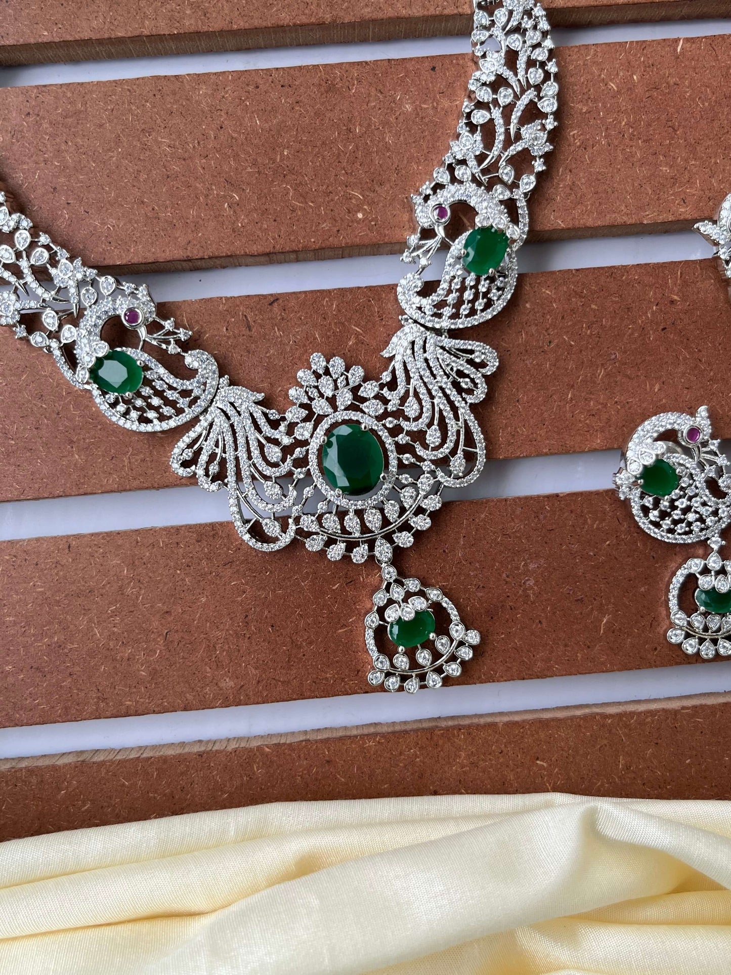 Silver Finish Peacock Design Necklace Set with Emerald Green Stones