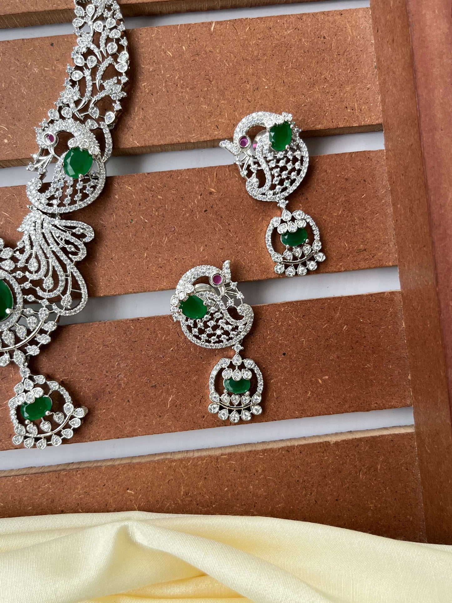 Silver Finish Peacock Design Necklace Set with Emerald Green Stones