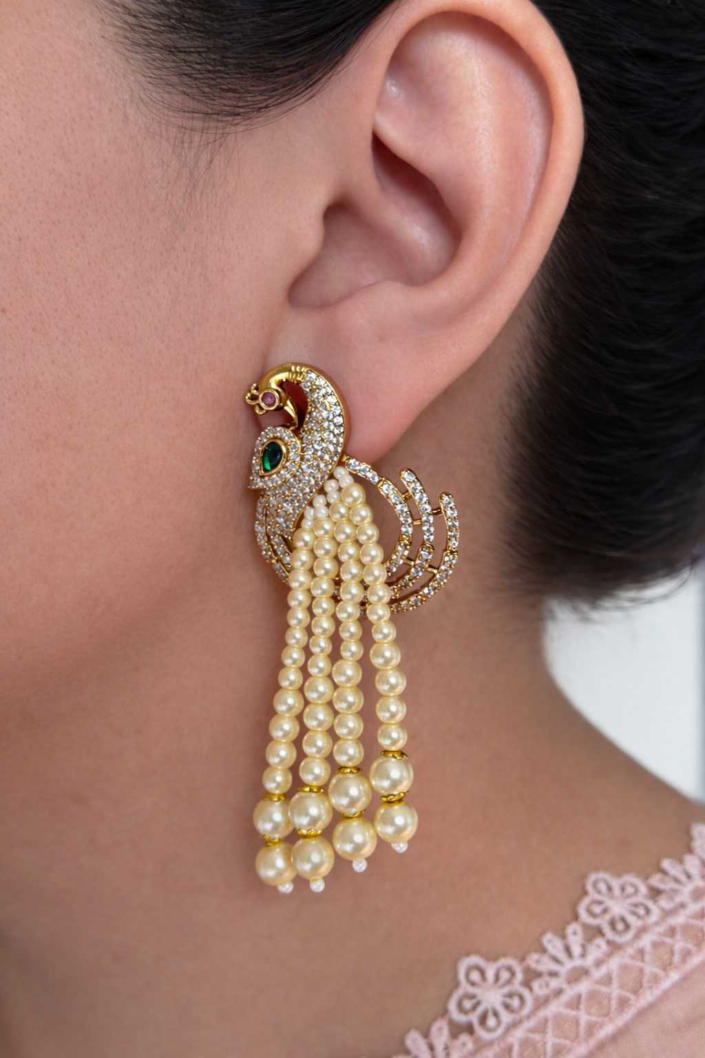 Royal peacock pearls hanging earrings worn by person