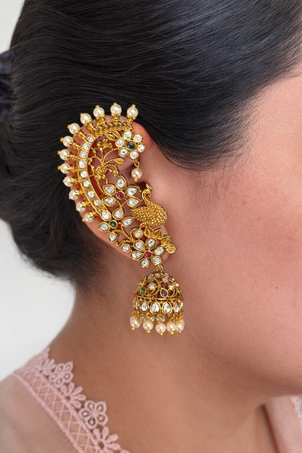 Kundan Earcuff Jhumka earring worn by a person with a neutral background. Bridal Jewellery